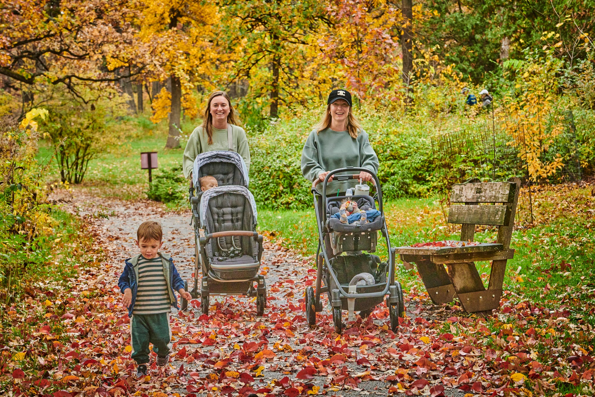 Photograph of two young mothers pushing strollers at The Morton Arboretum during fall