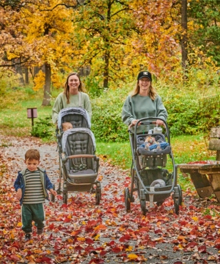Photograph of two young mothers pushing strollers at The Morton Arboretum during fall