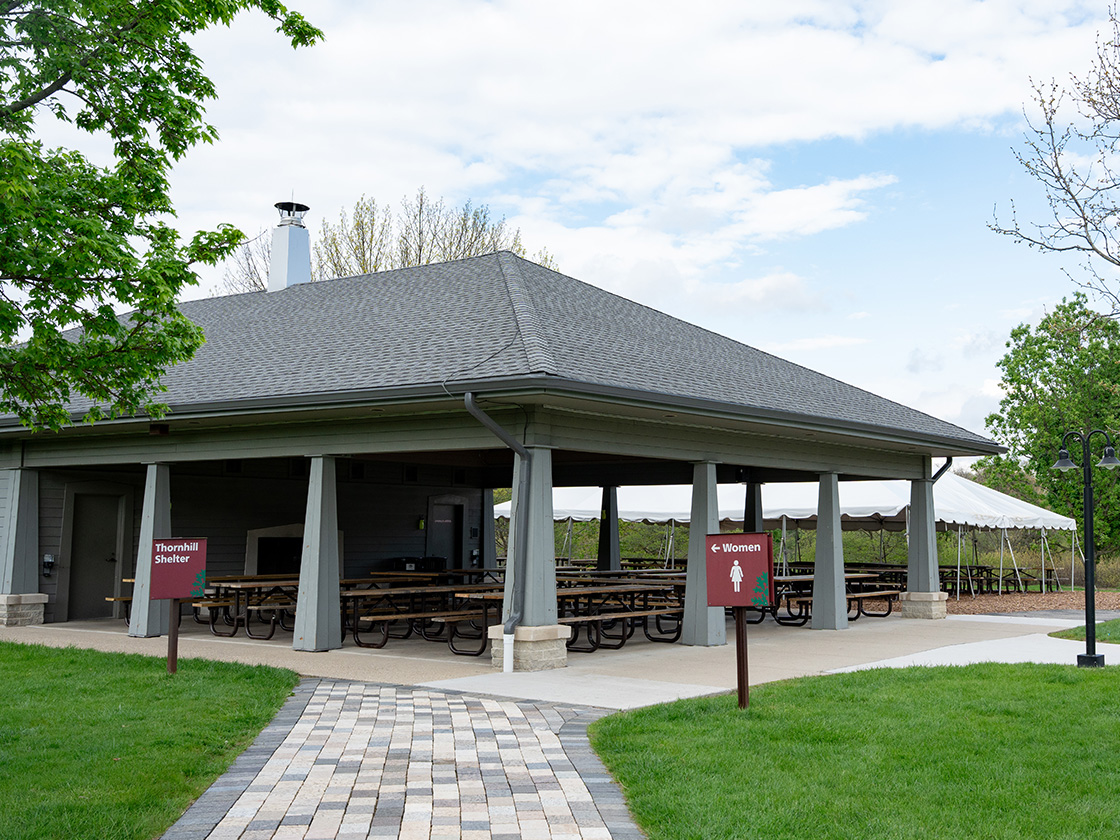 Photograph of the Thornhill Shelter with picnic tables at The Morton Arboretum