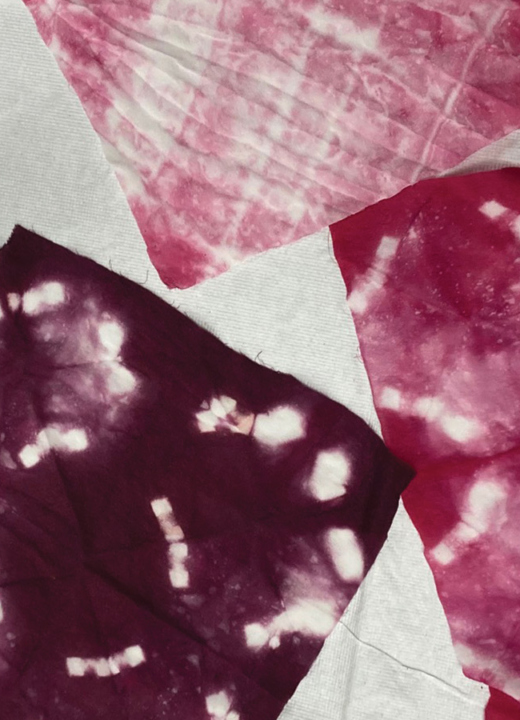 Squares of fabric dyed using Japanese tie-dye techniques with reddish-purple dye