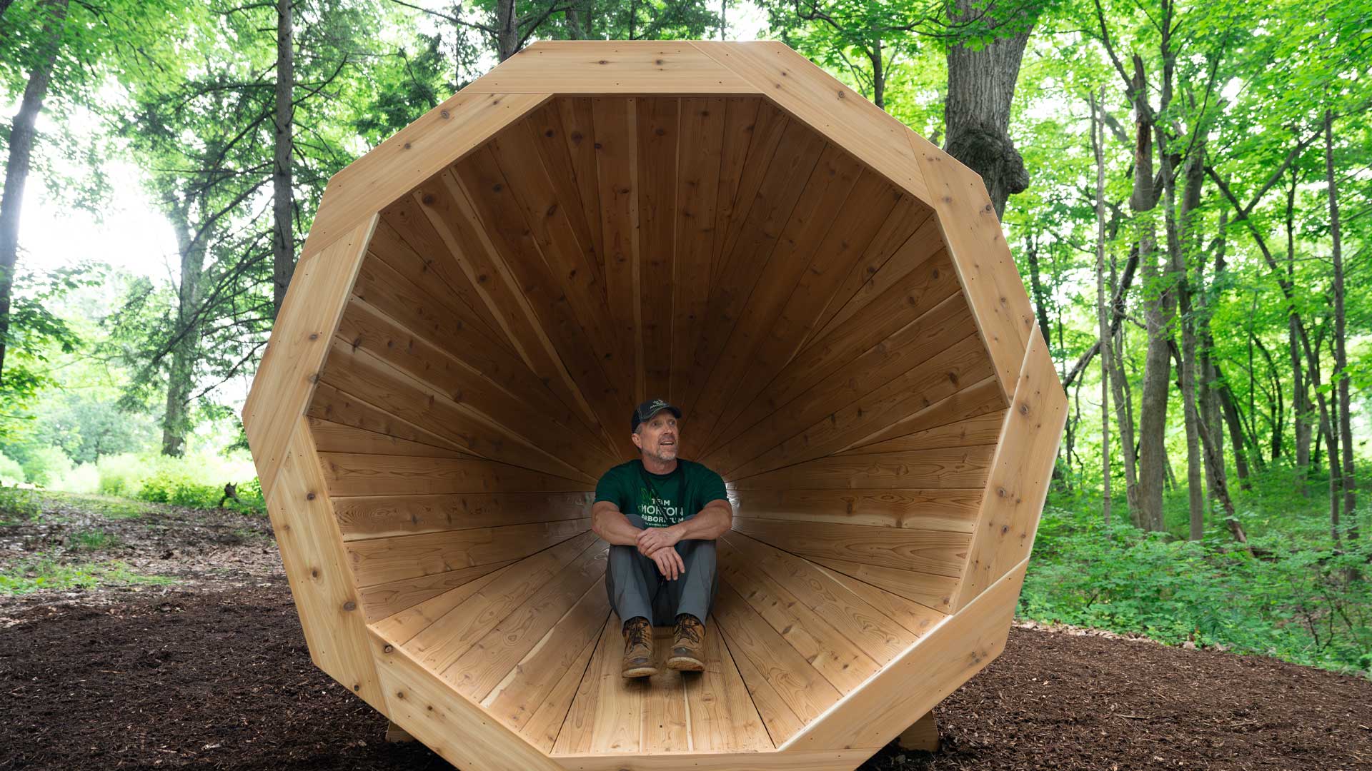 A guest enjoys sitting in the Nature Amplifier to hear the surrounding sounds of nature