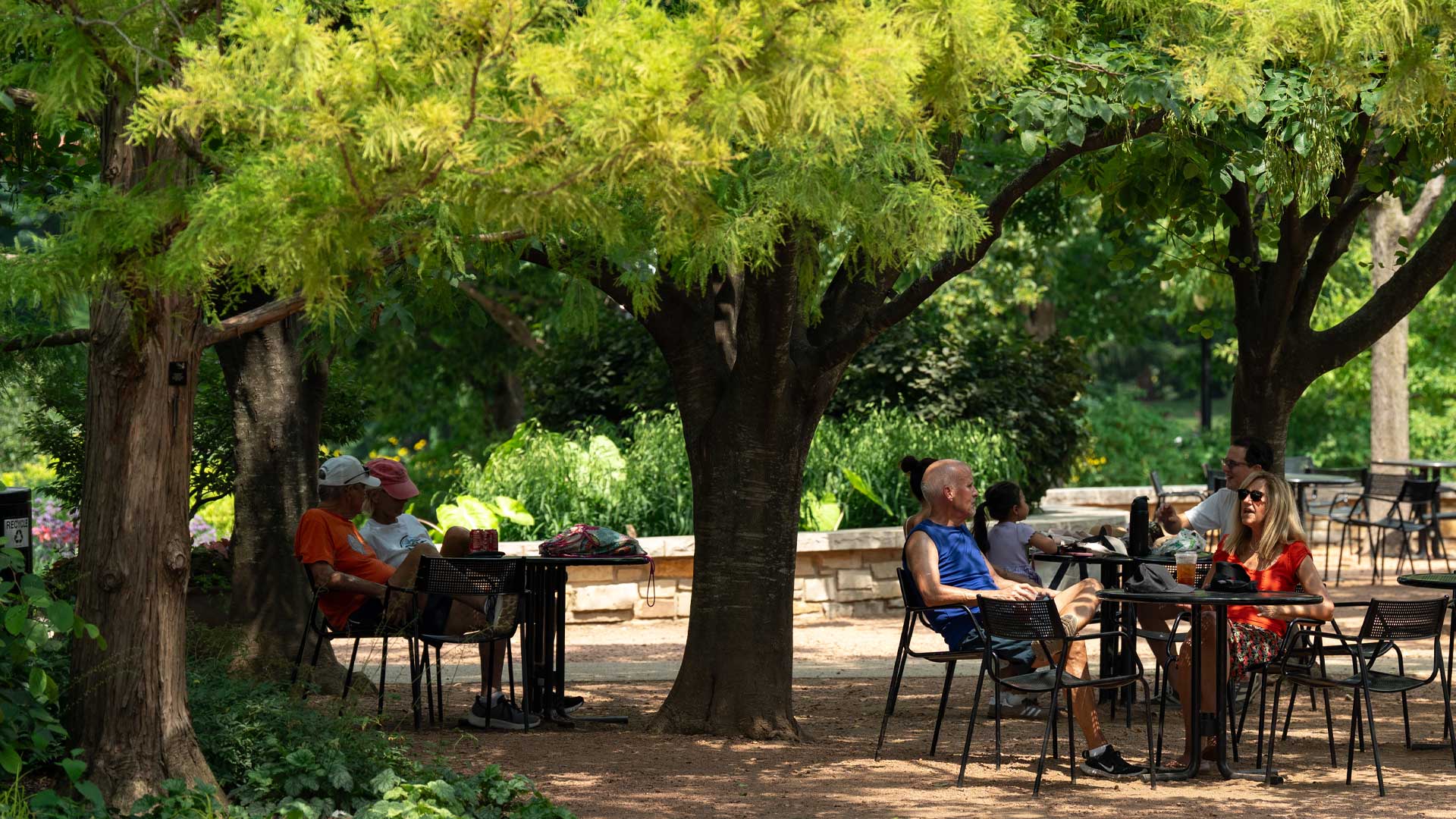 Guests embrace the shade on a hot summer day in Arbor Court